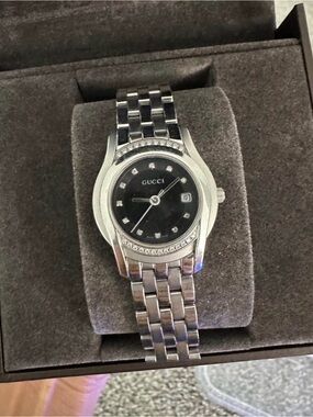 Gucci Silver Stainless Steel Watch with Black Dial and diamond Accents.